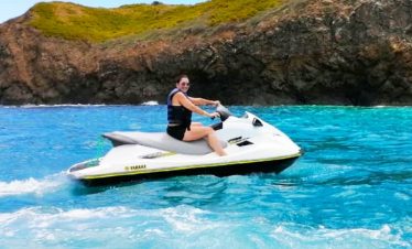 Person riding jet ski on water.