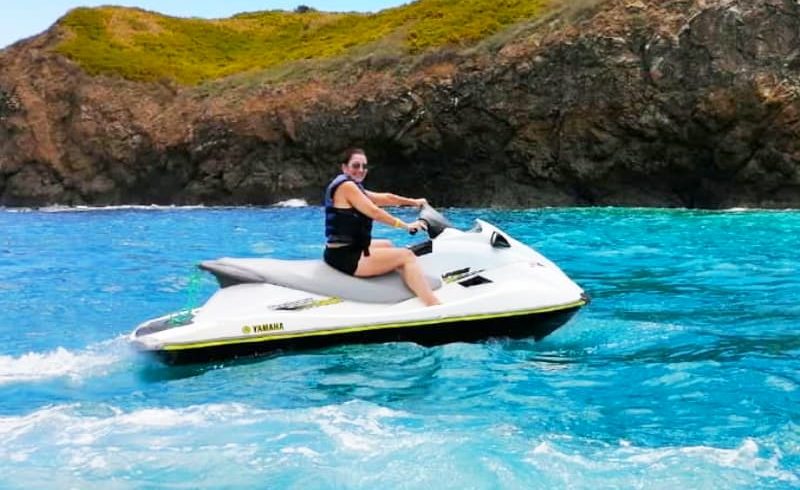 Person riding jet ski on water.