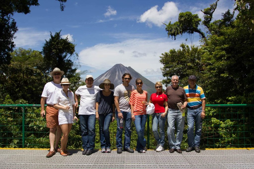 Group photo with volcano backdrop.