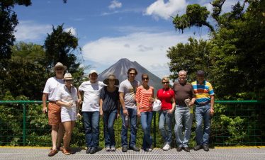 Group photo with volcano backdrop.