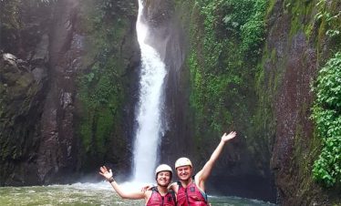 Two people by a waterfall.