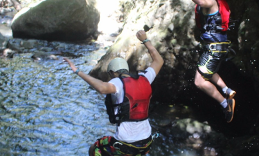 Two people jumping into water