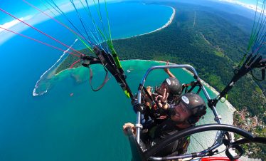 Aerial view of paratrike over coastline.