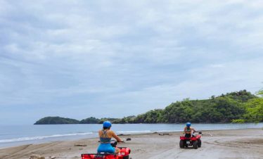 Two ATVs on a sandy beach