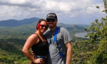 Couple enjoying a scenic mountain view.