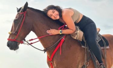 Person enjoying a horse ride.