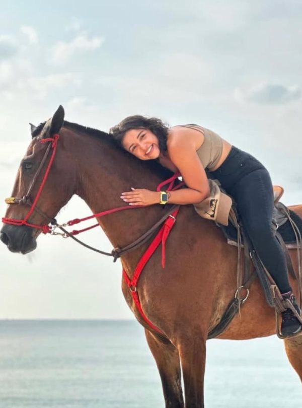 Person enjoying a horse ride.