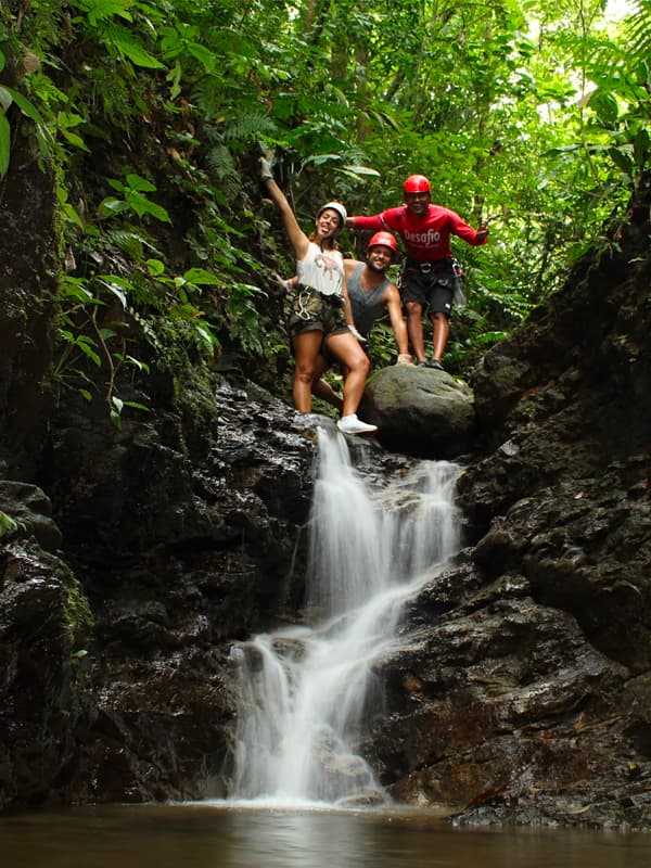 People near a waterfall in nature.