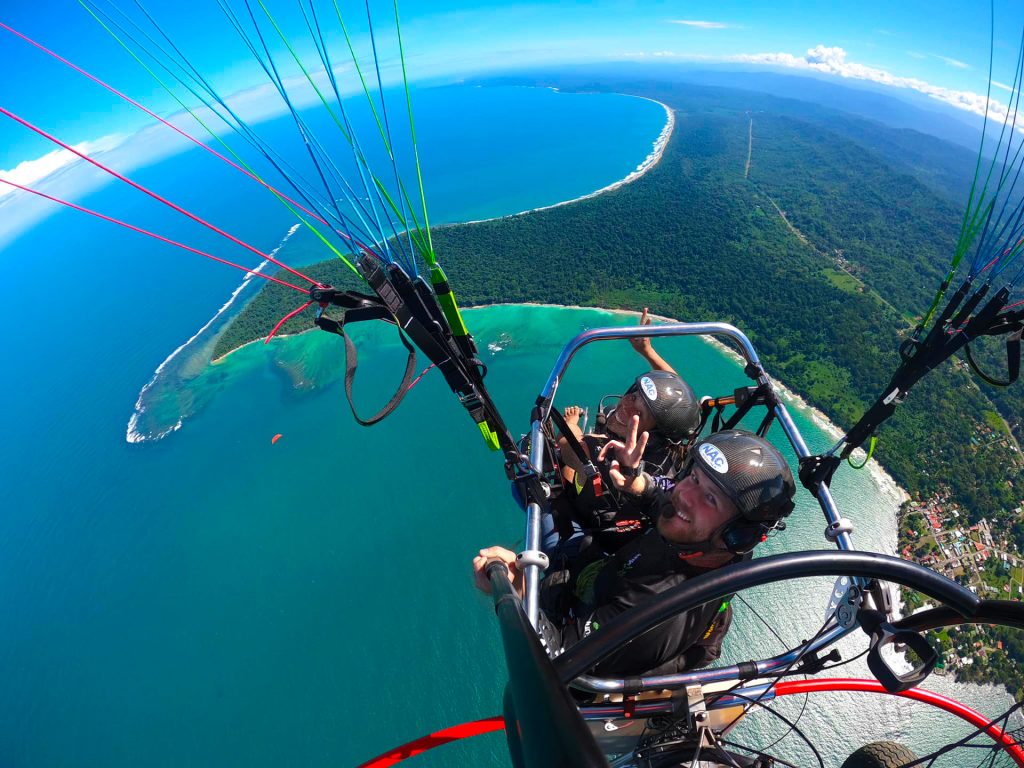 Aerial view of paratrike over coastline.