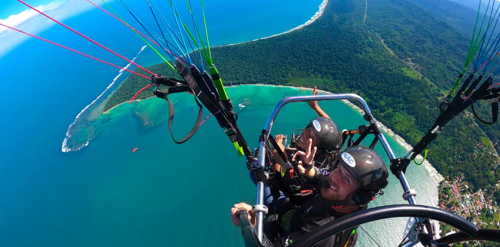 Aerial view of paratrike over coastline.