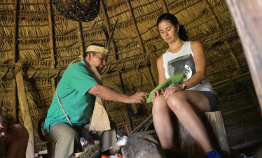 Shaman performing ritual in traditional setting.