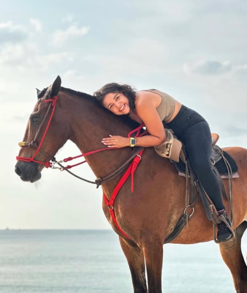 Person enjoying a horse ride.